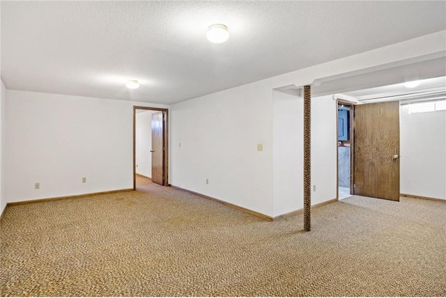 spare room featuring carpet and a textured ceiling