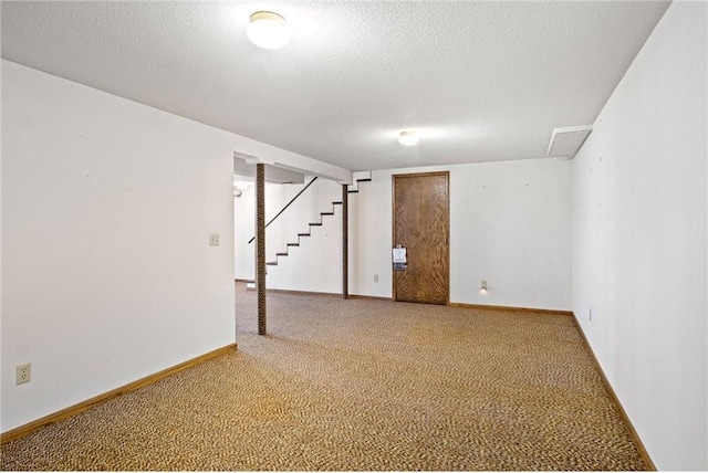 basement featuring carpet flooring and a textured ceiling