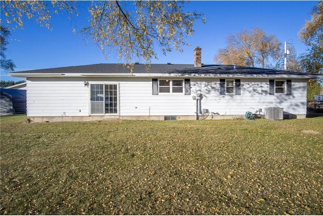 back of house featuring central AC and a yard