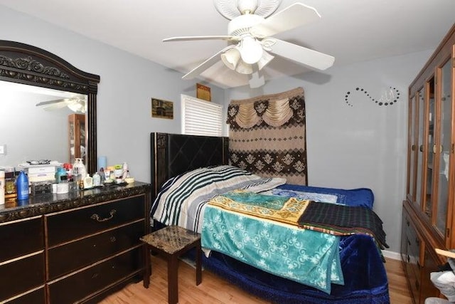 bedroom with ceiling fan and light wood-type flooring