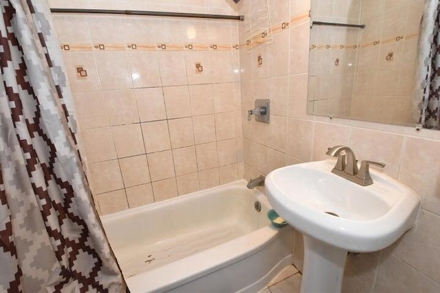 bathroom with shower / bath combination with curtain, backsplash, and tile walls