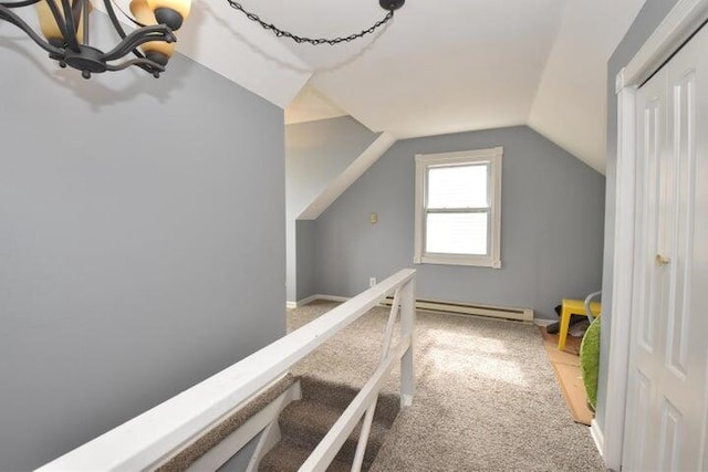 additional living space featuring baseboard heating, lofted ceiling, and carpet flooring