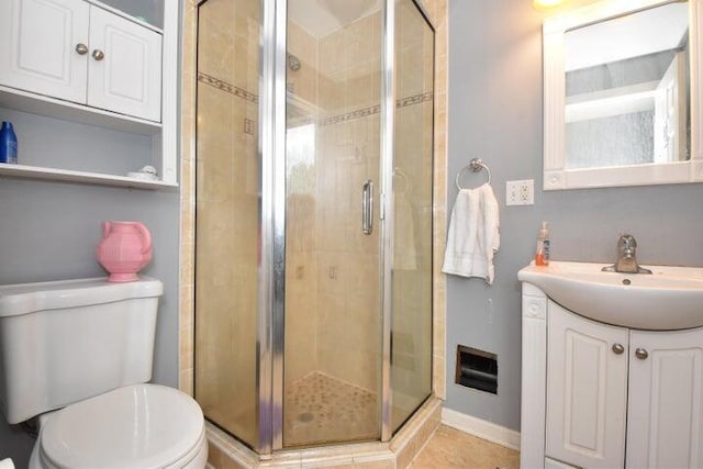 bathroom featuring toilet, an enclosed shower, and vanity