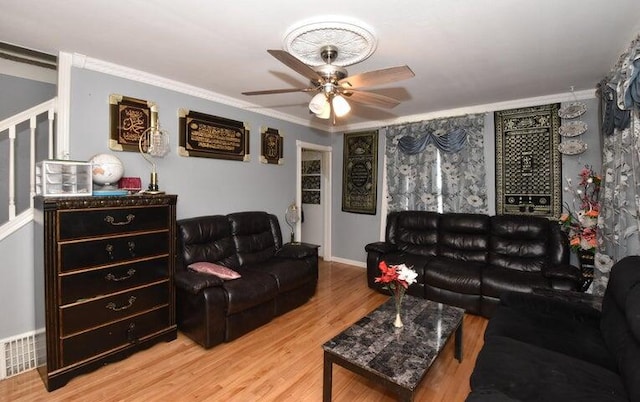 living room with ceiling fan, hardwood / wood-style flooring, and ornamental molding