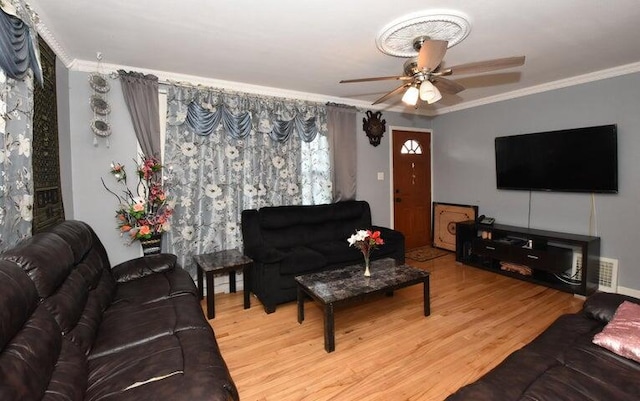 living room with ceiling fan, crown molding, and hardwood / wood-style floors