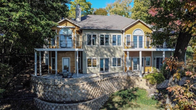 back of house featuring a balcony and a patio area