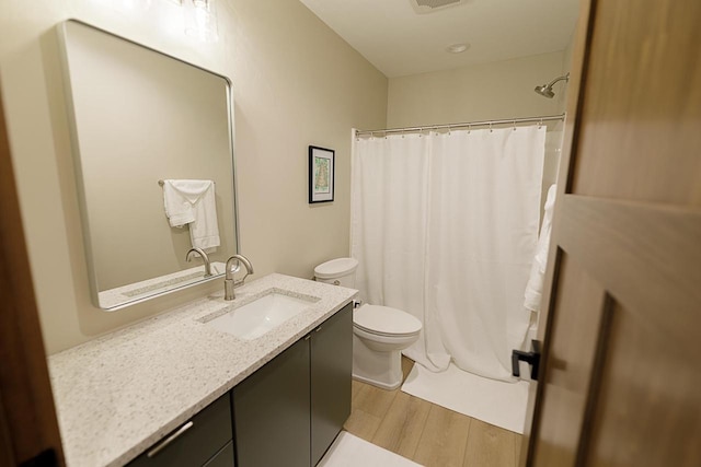 bathroom with vanity, toilet, hardwood / wood-style flooring, and a shower with shower curtain