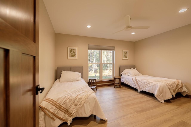 bedroom featuring light wood-type flooring and ceiling fan