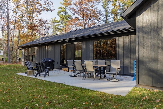 rear view of property with a yard and a patio area