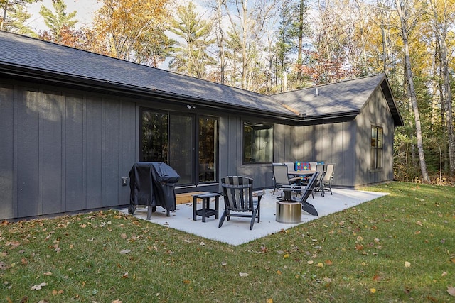 rear view of house featuring a yard and a patio