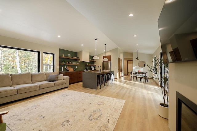 6280 Breezewood Ln, Sturgeon Bay, WI 54235 - living area featuring vaulted ceiling, light wood-style floors, and recessed lighting