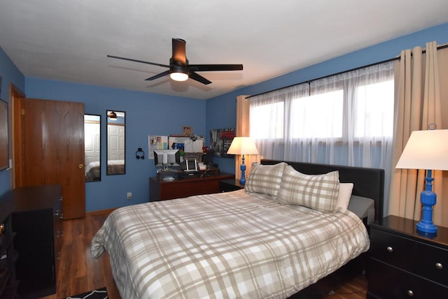 bedroom with dark hardwood / wood-style floors and ceiling fan