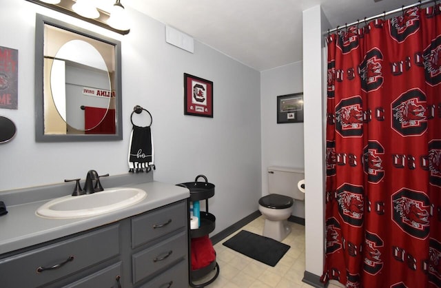 bathroom featuring vanity, toilet, and a shower with curtain