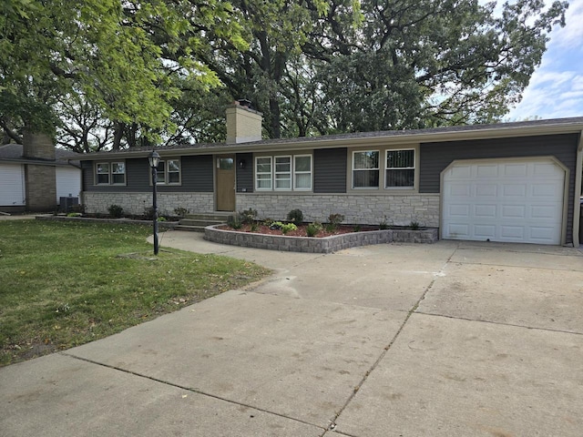 ranch-style home featuring a front yard, central AC unit, and a garage