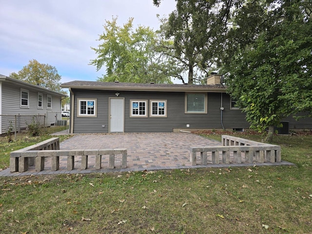 view of front of property featuring a patio area, central AC, and a front lawn