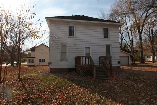 back of house featuring a garage and an outdoor structure