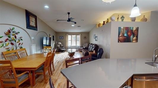 dining space featuring ceiling fan, light hardwood / wood-style flooring, and sink