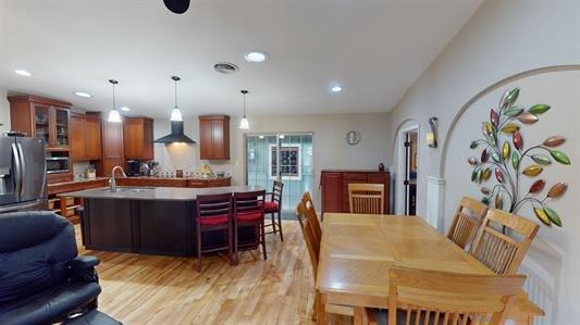 dining space featuring sink and light hardwood / wood-style flooring