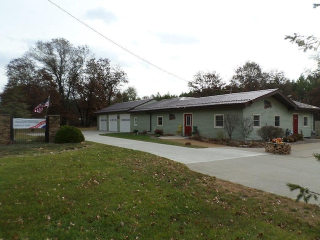 ranch-style house featuring a garage and a front yard