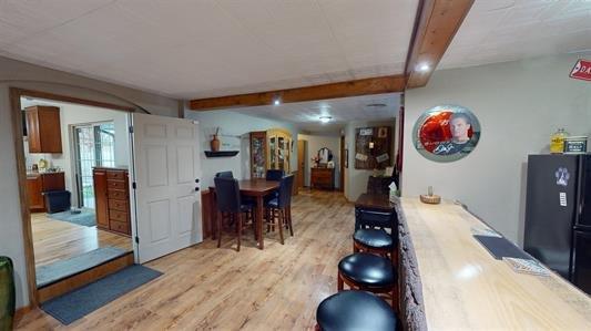 interior space featuring light hardwood / wood-style flooring and beamed ceiling