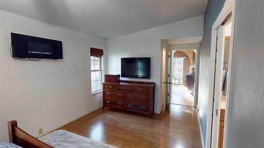 bedroom featuring hardwood / wood-style floors and vaulted ceiling