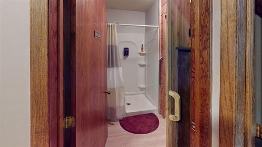 bathroom featuring hardwood / wood-style floors and a shower with curtain