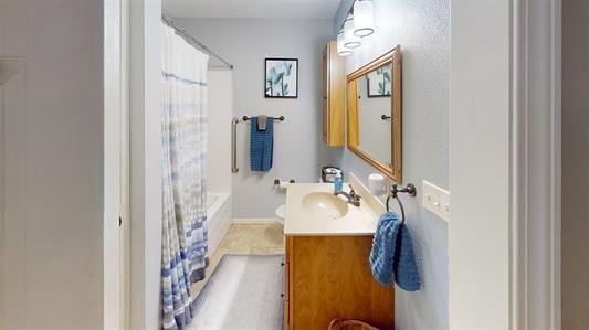 bathroom with tile patterned floors, vanity, and shower / bath combo