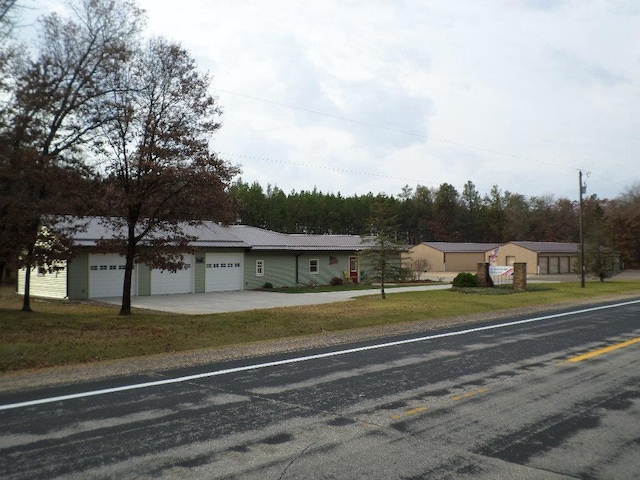 ranch-style home with a garage and a front lawn