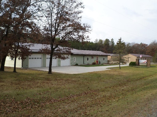 single story home featuring a front lawn and a garage