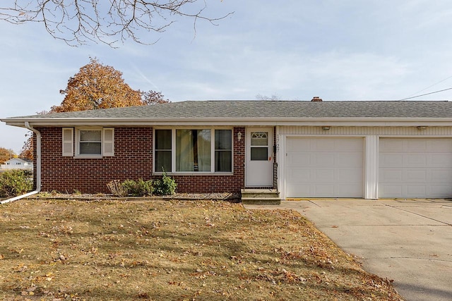 ranch-style house with a front lawn and a garage