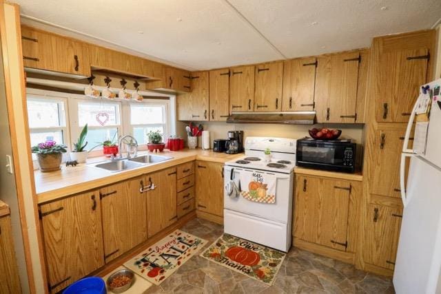 kitchen featuring white appliances and sink