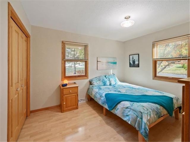 bedroom featuring light hardwood / wood-style floors and a closet