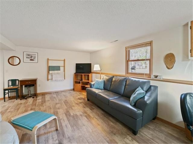 living room featuring hardwood / wood-style flooring and a textured ceiling