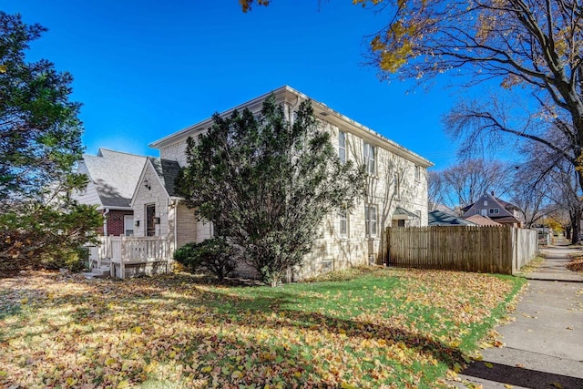 view of side of home with a lawn