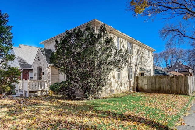 view of side of home with a yard