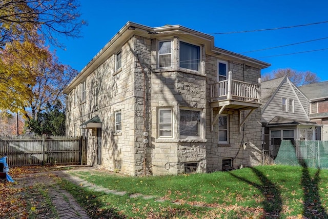 back of house featuring a balcony