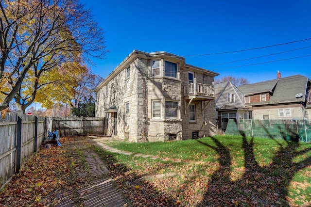 back of house with a balcony