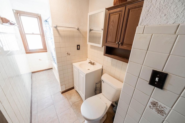 full bathroom with shower / tub combo, toilet, tile walls, vanity, and tile patterned flooring