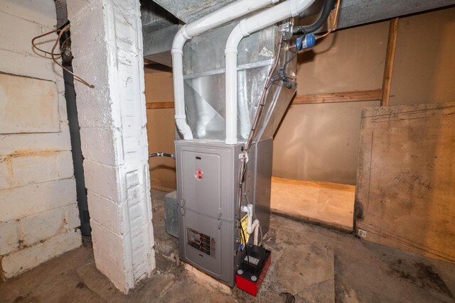 utility room featuring heating unit