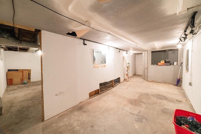 basement featuring a textured ceiling