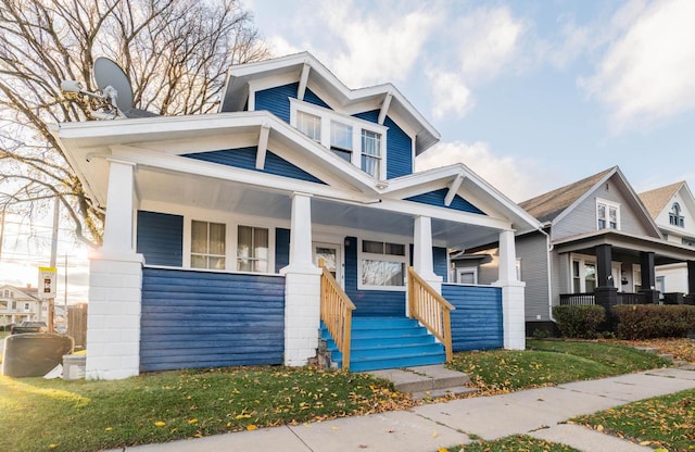 view of front of property with a porch and a front yard