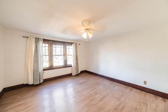 unfurnished room with hardwood / wood-style flooring and ceiling fan