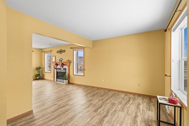 unfurnished living room featuring light hardwood / wood-style floors and a wealth of natural light