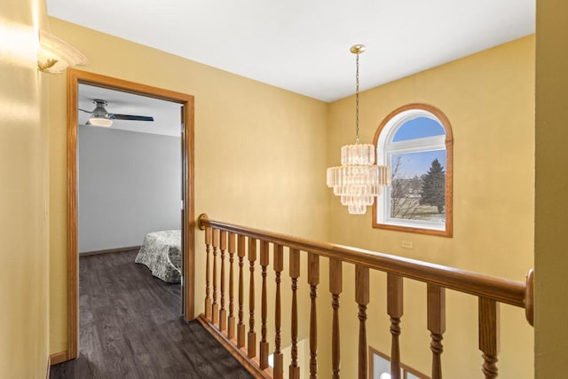 hall with dark hardwood / wood-style flooring and a chandelier