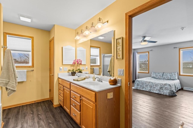 bathroom featuring ceiling fan, a wealth of natural light, vanity, and hardwood / wood-style flooring