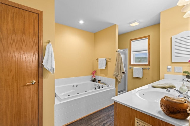 bathroom featuring separate shower and tub, hardwood / wood-style floors, and vanity