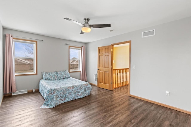 bedroom with ceiling fan and dark hardwood / wood-style flooring