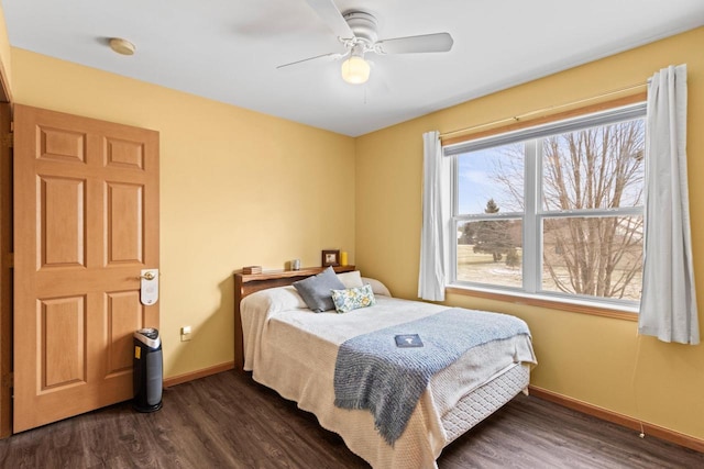 bedroom with ceiling fan and dark hardwood / wood-style floors