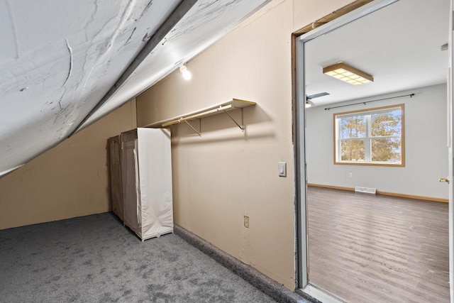 additional living space featuring lofted ceiling and hardwood / wood-style flooring