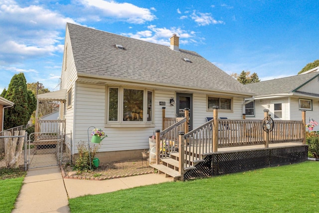 view of front of property with a wooden deck and a front lawn